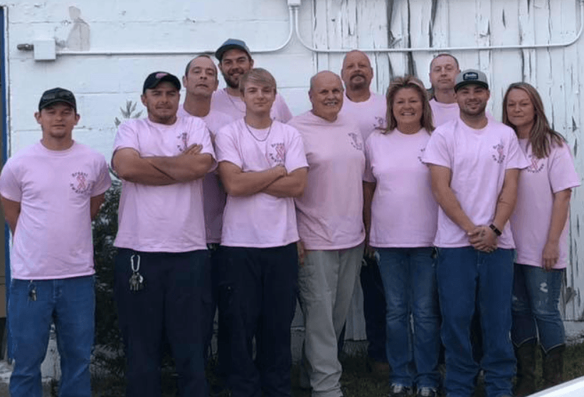 G & R Services team in matching pink shirts for breast cancer awareness